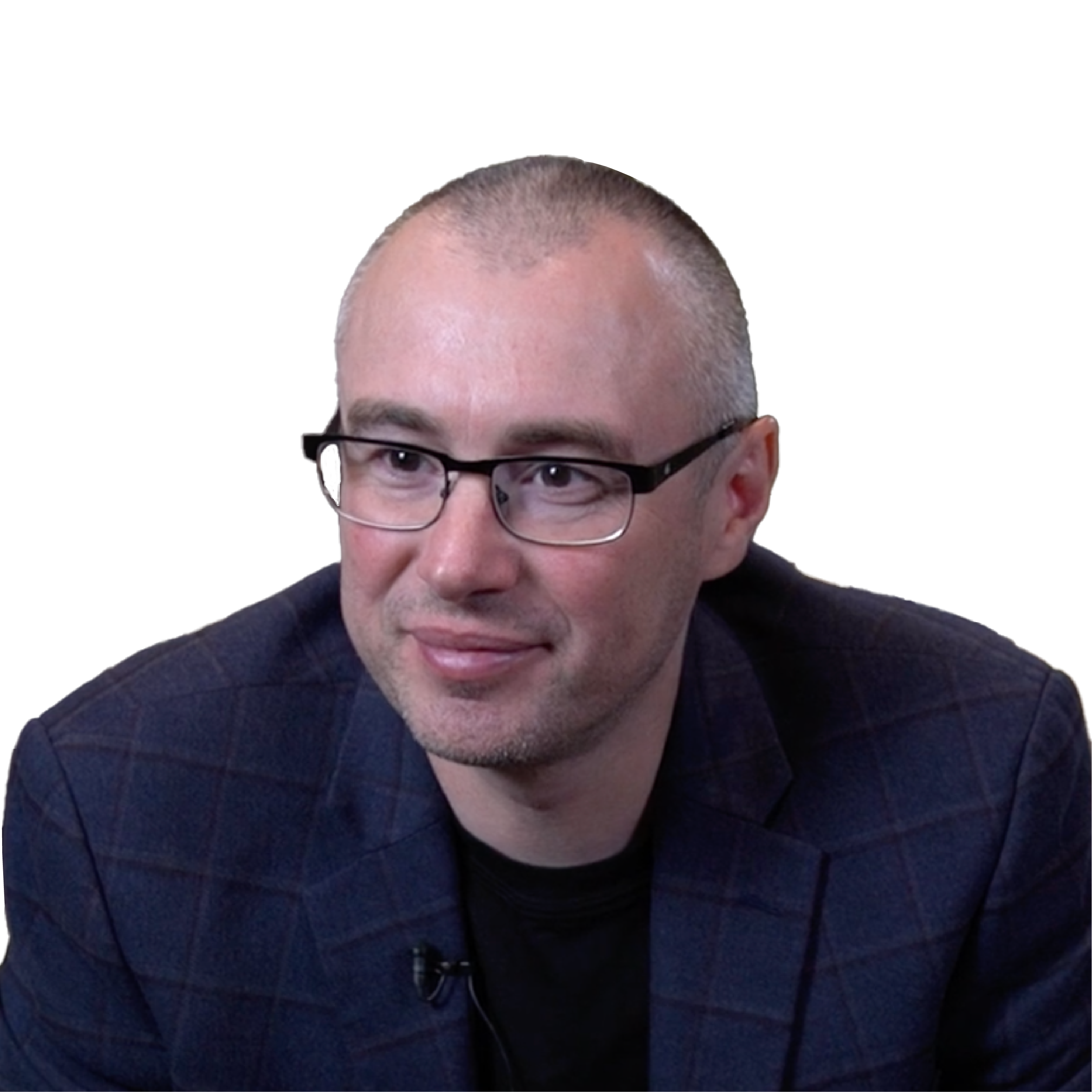 Close-up of a light-skinned man wearing glasses and looking into the camera.