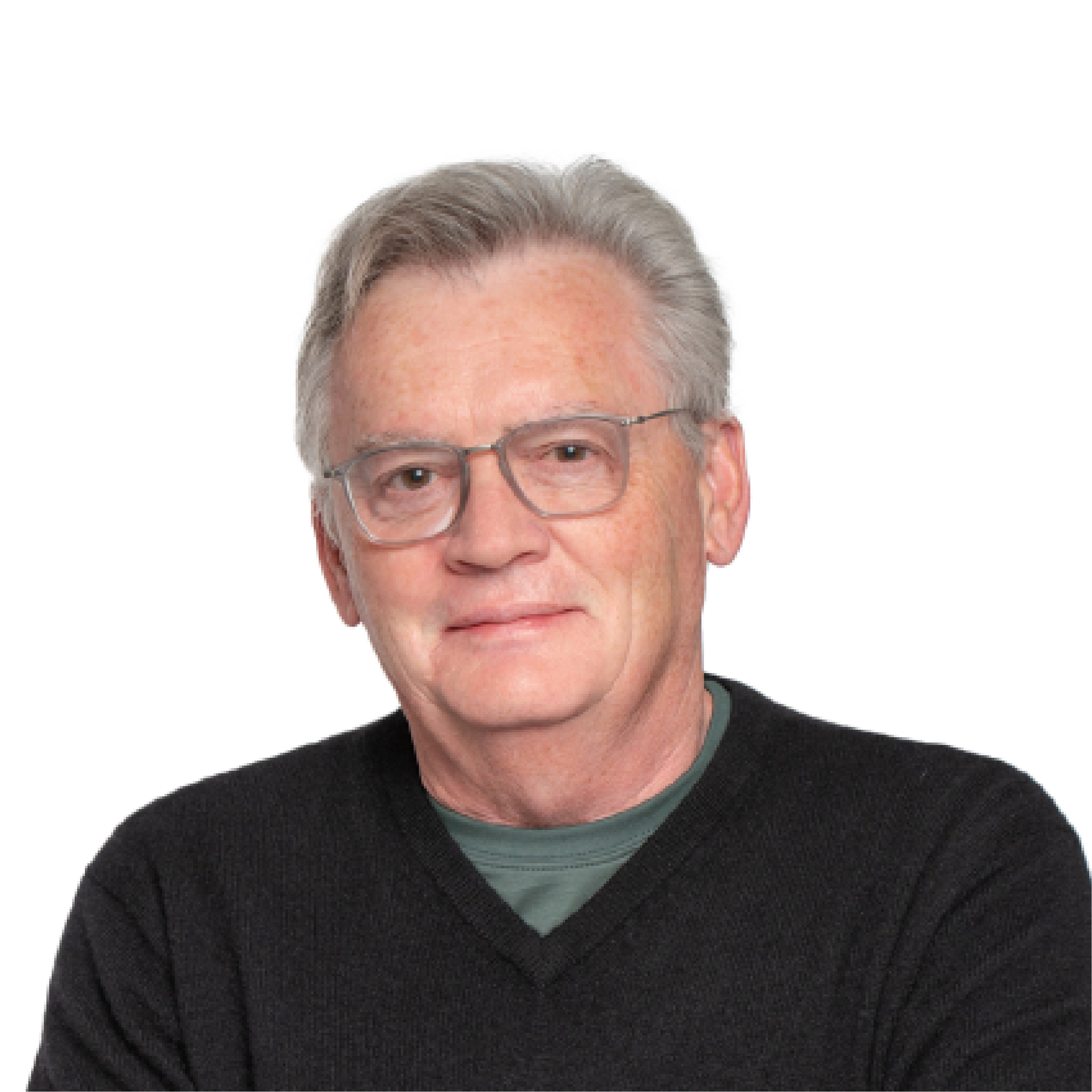 Headshot of an older man wearing glasses and a sweater and looking directly into the camera.